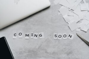 pexels photo 4271927 4271927 A creative arrangement with paper cutouts spelling 'Coming Soon' on a textured surface.